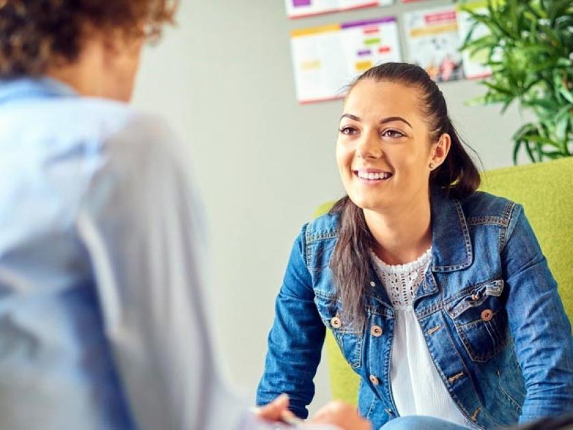 A student talking to a counselor in an office